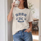 A woman wearing an off-white graphic t-shirt featuring a vintage Korean heritage design. The shirt displays the Korean text "대한민국" (Republic of Korea) in a distressed blue font