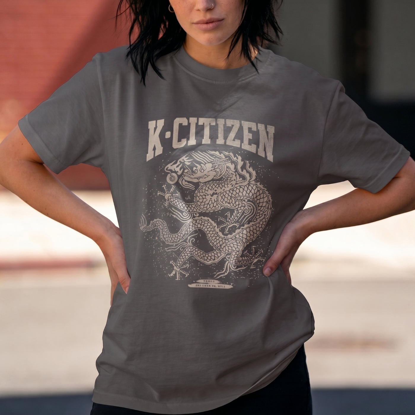 Person wearing a gray t-shirt with a dragon graphic and 'K-Citizen' text.