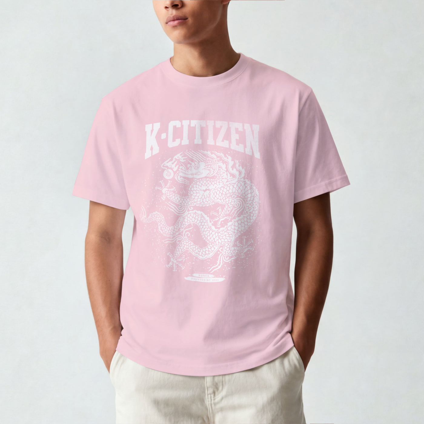 Person wearing a pink t-shirt with 'K-Citizen' logo on a plain background