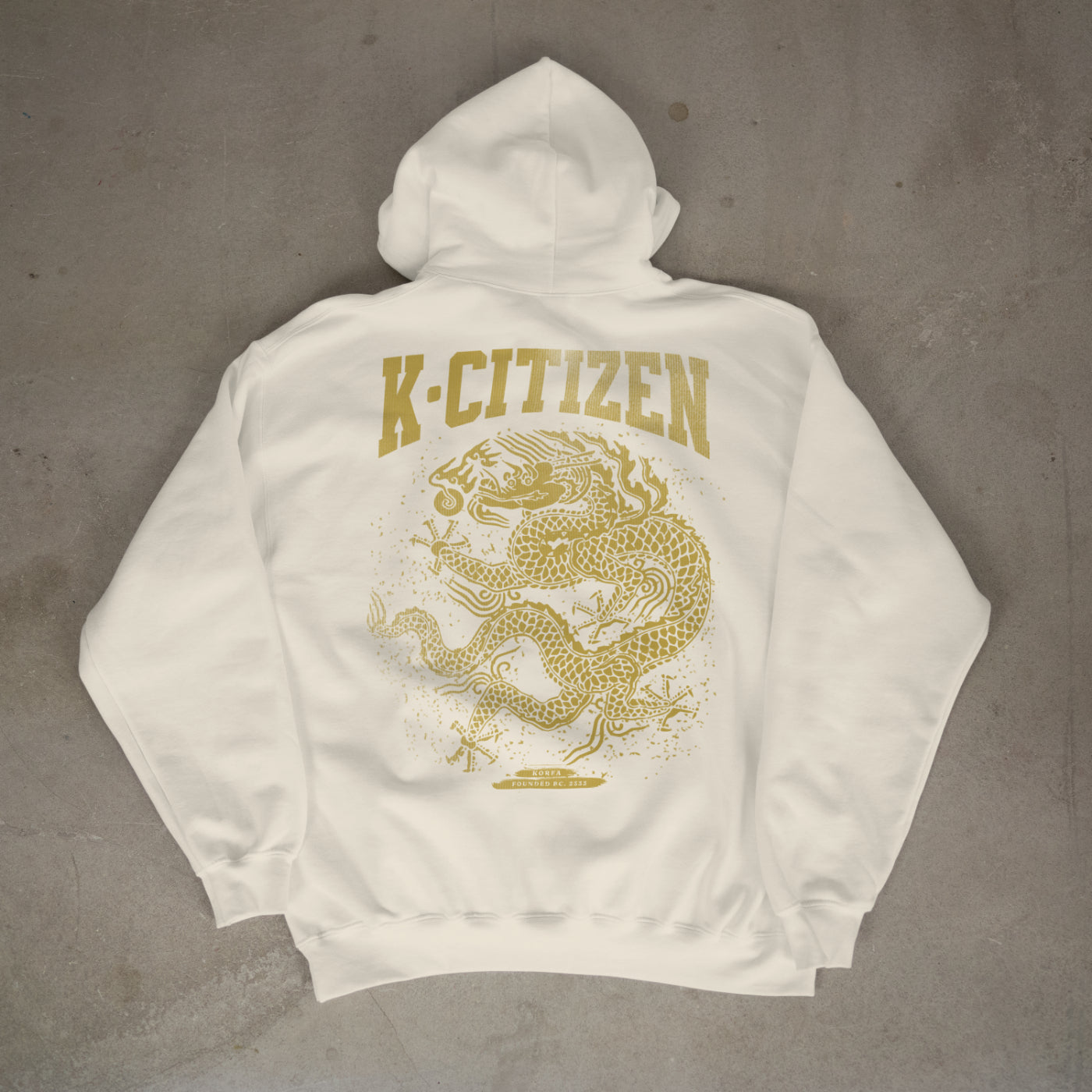 White hoodie with gold 'K-Citizen' logo and dragon design on a gray background
